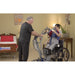 Bestcare SA400 ProCare sit-to-stand lift with person in sling lowering in new condition