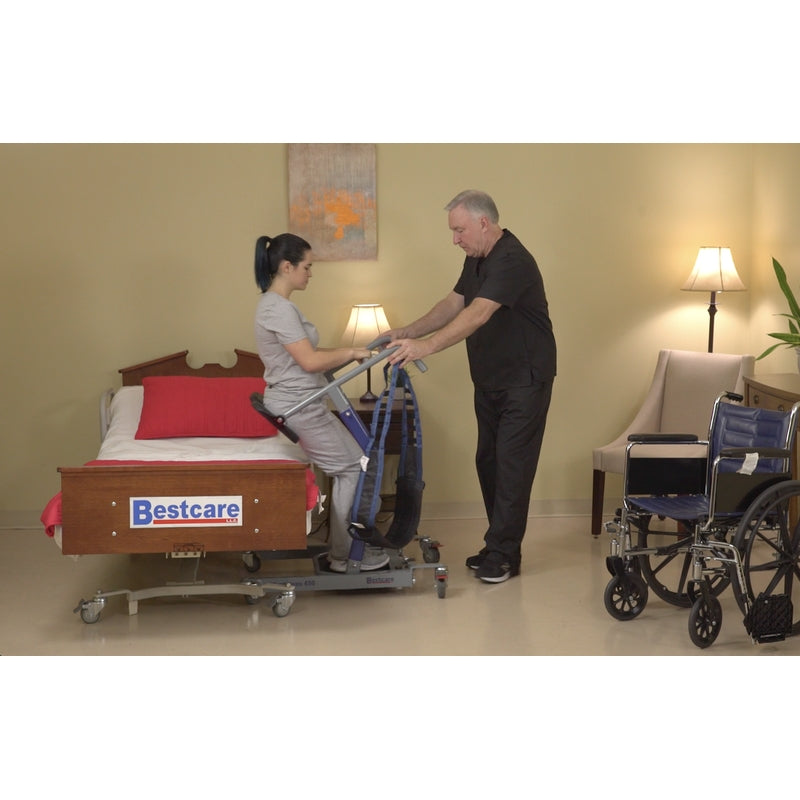Bestcare STA450 BestMove standing transfer aid front view with person lowering onto the bed in new condition