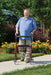 Older genterman walking with walkabout lite rollator